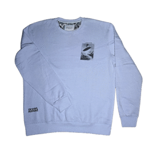 👕 Buzo celeste gastado Denim & Flower Ricky Singh de tela suave. Estampa frontal pequeña de tabla de surf. Estampa trasera grande "ocean nomad" con playa y surf.